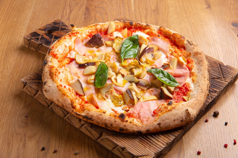 Prosciutto and arugula pizza with shaved parmesan