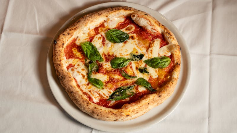 Classic Margherita pizza with fresh basil and mozzarella